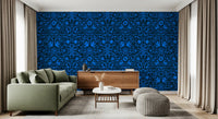 Blue folk art wall behind a sage green sofa and wood sideboard with a pouf GD12263
