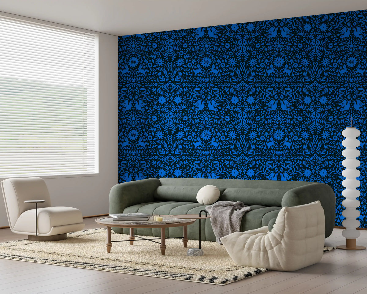 Cobalt folk art wallpaper behind a sage green sofa and round coffee table GD12263