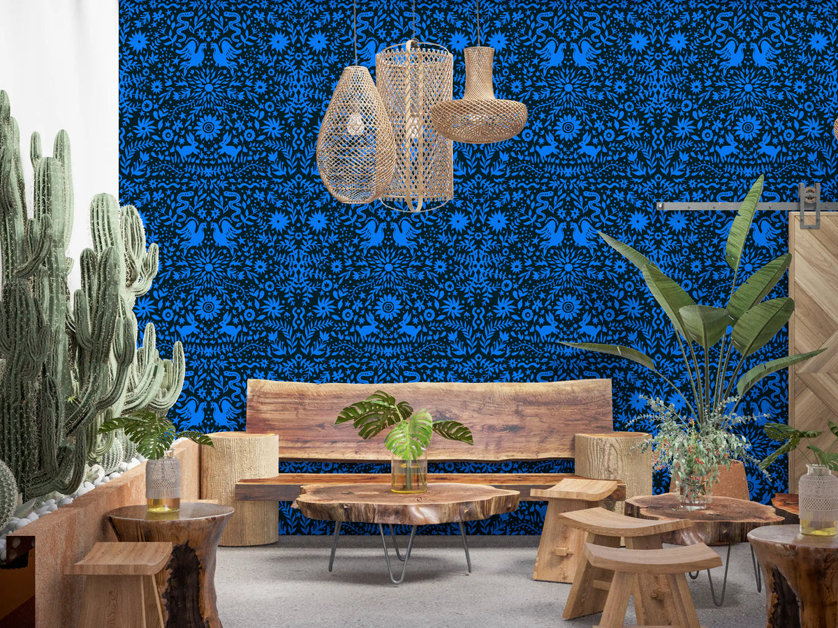 Blue folk art wall in a rustic room with cactus and live-edge wood tables GD12263