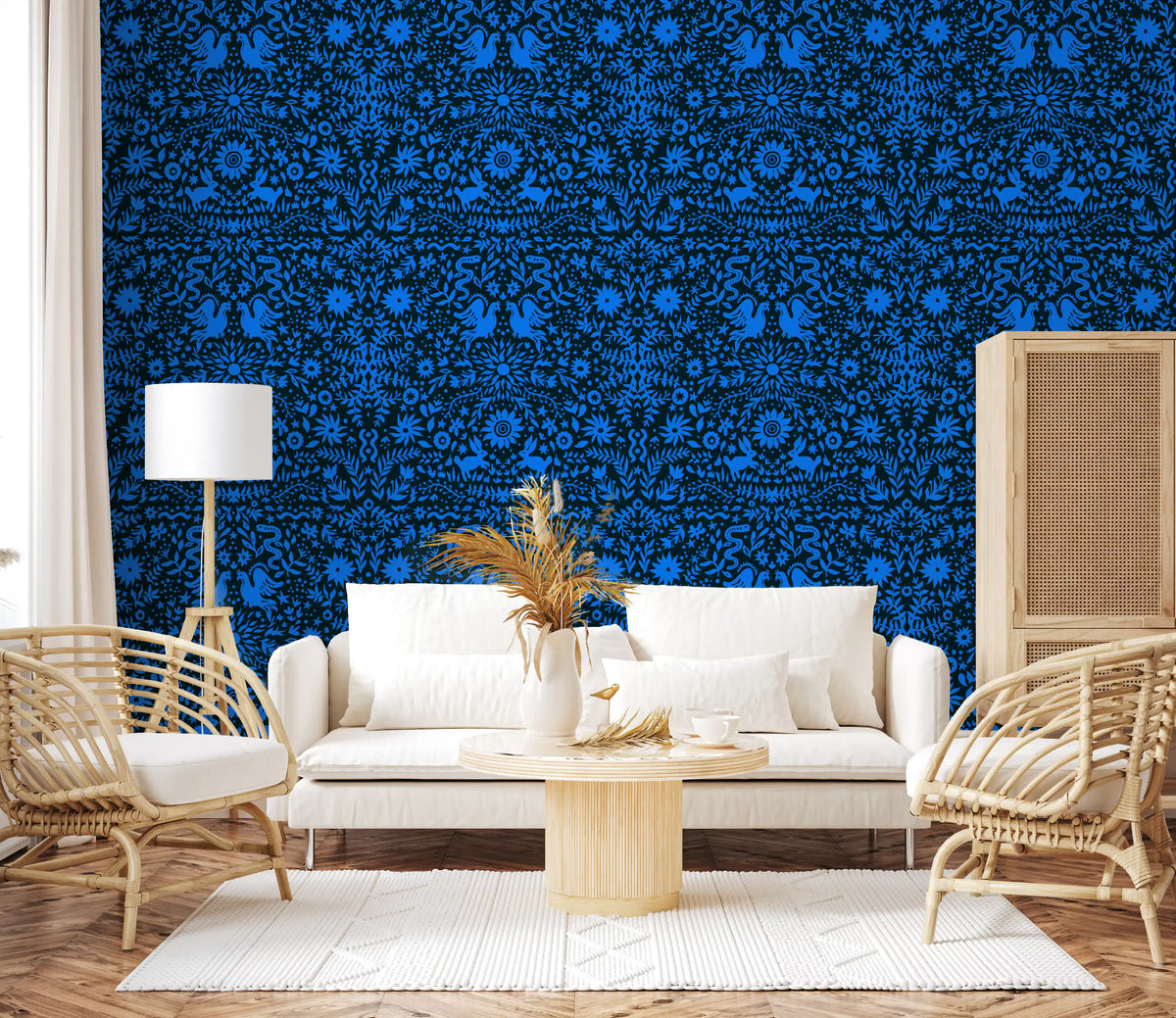 Blue folk art wall behind a white sofa with cane chairs and pampas grass GD12263