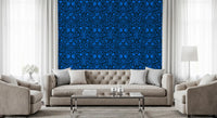 Cobalt folk art wallpaper behind a grey tufted sofa between tall curtained windows GD12263