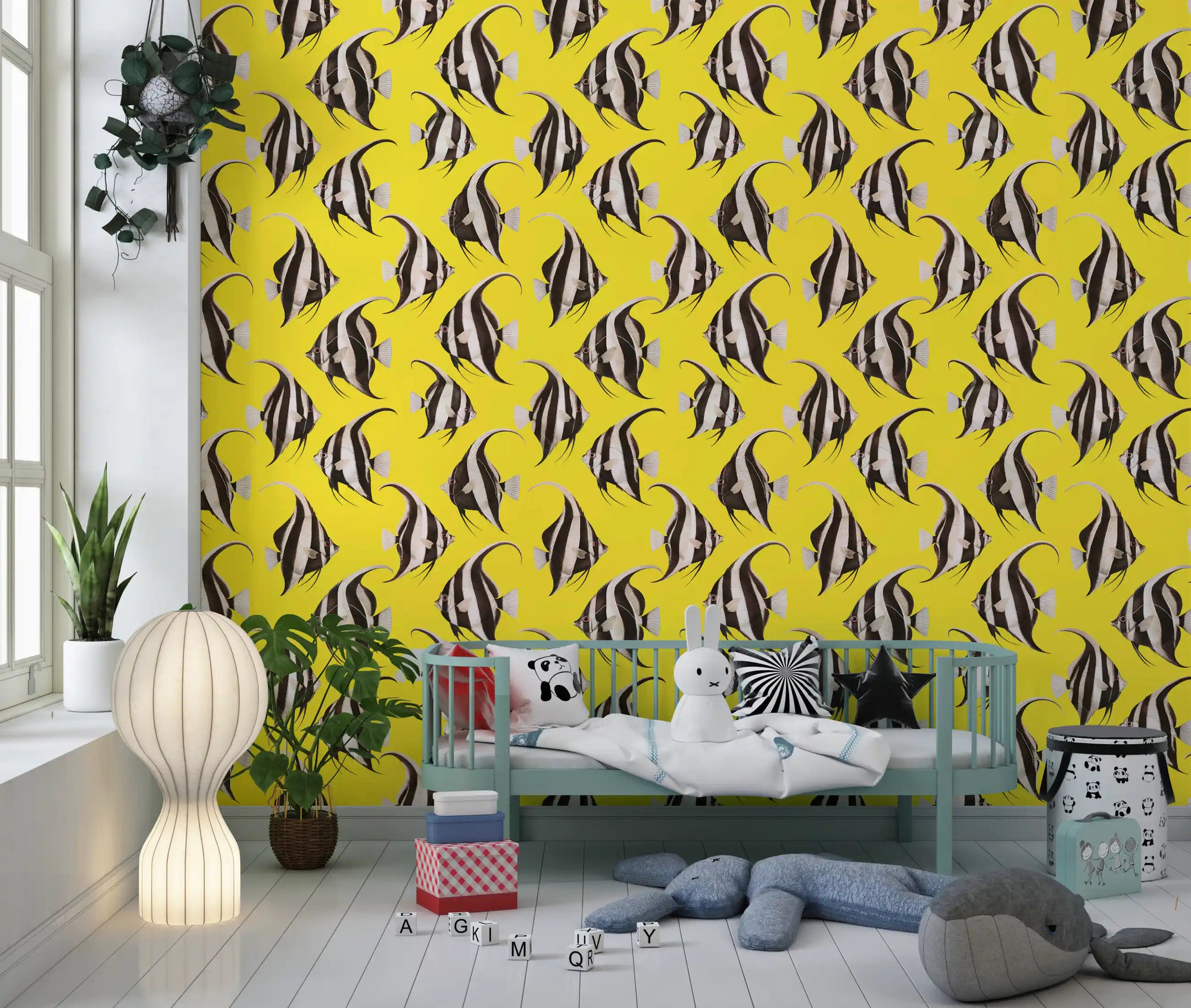 Yellow angelfish wallpaper behind a teal kids daybed with plush toys and a lantern lamp GD12276