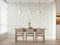 Green leaf wallpaper in a dining room with white pendant lights and pale chairs GD12282