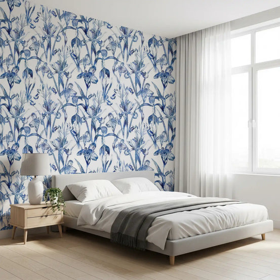 Indigo botanical sketch wallpaper behind a grey bed and wood nightstand in a bright bedroom GD12287