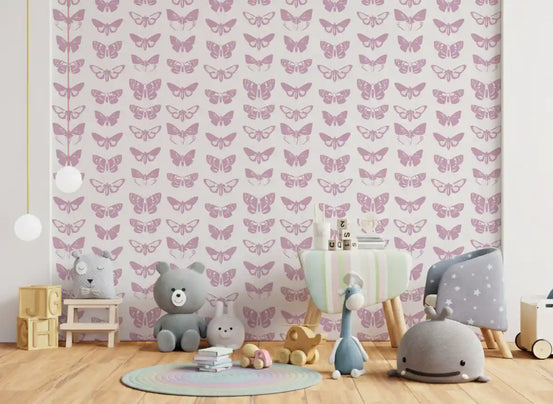 Soft pink moth assemblage wallpaper in a nursery with a grey teddy bear and wooden toys GD12294