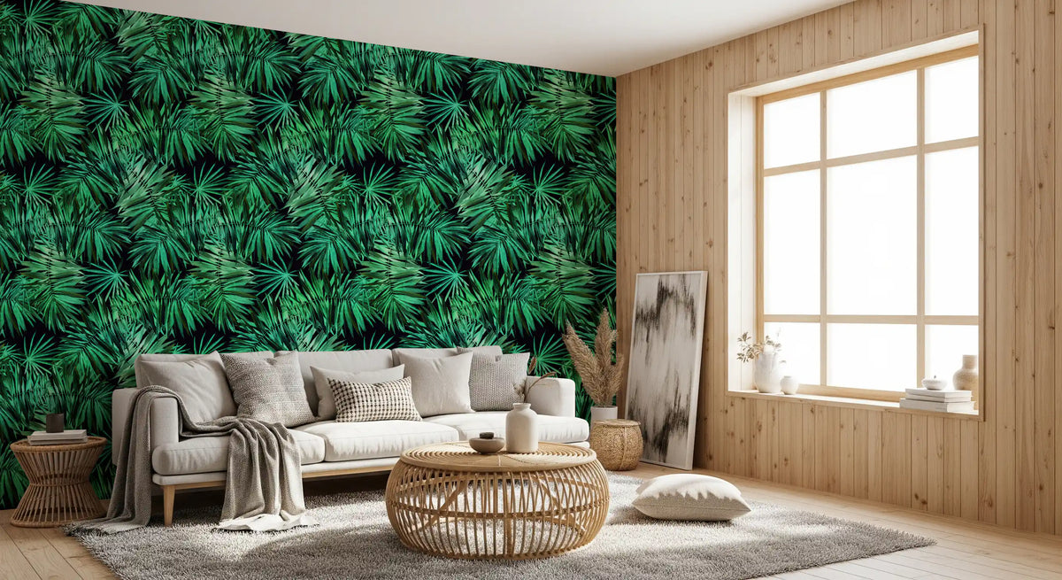Tropical palm canopy wallpaper in a cosy reading corner with a cream armchair and rattan table GD12296