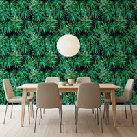 Palm canopy wallpaper behind a wooden dining table with beige chairs and a paper lantern GD12296