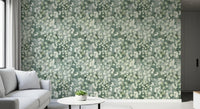 Grey sofa corner with round white side table and eucalyptus brushstroke wallpaper GD12324