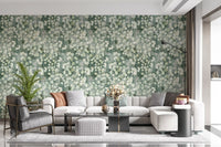 Cream sofa and armchair with poufs framed by eucalyptus brushstroke wallpaper GD12324