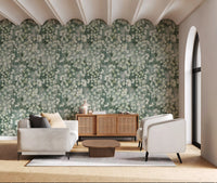 Cream armchairs and wooden sideboard by arched doorway on eucalyptus wallpaper GD12324