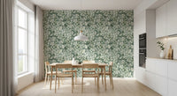 Bright dining nook with light wood table and chairs against eucalyptus brushstroke wallpaper GD12324
