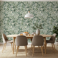 Wooden dining table and taupe chairs on jute rug against eucalyptus mist wallpaper GD12324