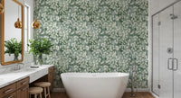 Freestanding white tub and wood vanity against green eucalyptus brushstroke wallpaper GD12324