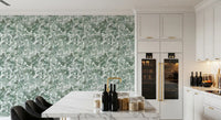 White marble kitchen island and wine fridge against green leaf canopy wallpaper GD12325