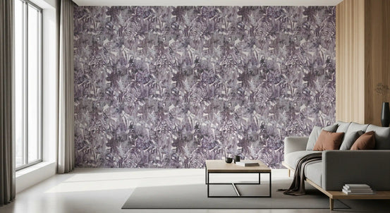 Monochromatic foliage wallpaper behind a grey sofa and gold-framed mirror in a living room GD12330