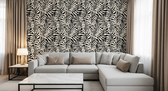 Cream and black palm leaf wallpaper behind a grey sectional with a marble coffee table GD12342