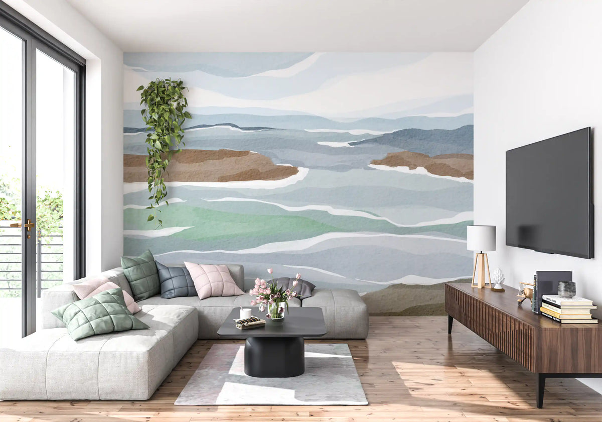 Watercolour ocean view wall mural behind a white sectional sofa and wood TV console in a lounge GD12402