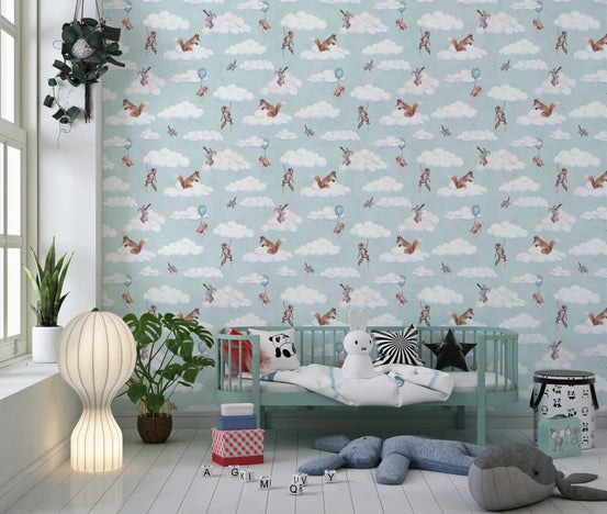 Floating forest friends wallpaper in a nursery with a mint crib and plush elephant GD12418