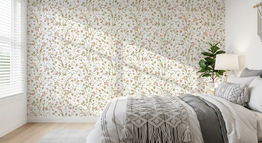 Meadow wildflower wallpaper in a bedroom with a grey bed macrame throw and potted plant GD12437