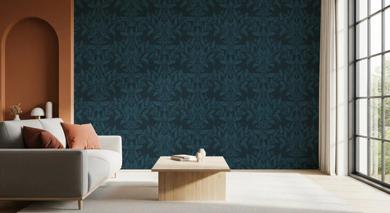 Enchanted ink leaf motif wallpaper behind a grey sofa near an arched terracotta doorway GD12456