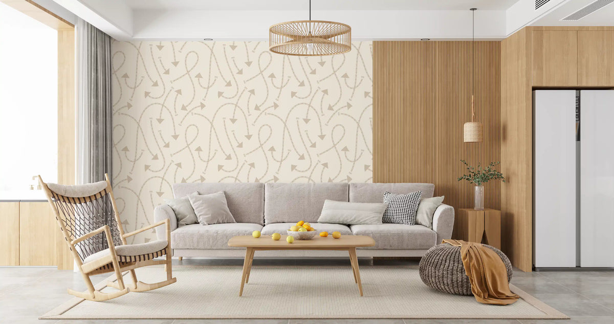 Cream geometric path wallpaper behind a grey sofa with a rattan rocking chair GD12457