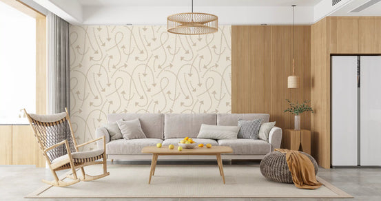 Cream geometric path wallpaper behind a grey sofa with a rattan rocking chair GD12457