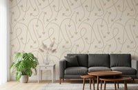 Geometric path wallpaper behind a dark grey sofa with a leafy monstera plant GD12457