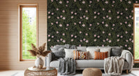 Soft pink floral wallpaper behind a grey sofa with pampas grass and a rattan table GD12467