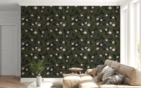 Charcoal floral vine wallpaper behind a cream sectional with a small potted plant GD12467