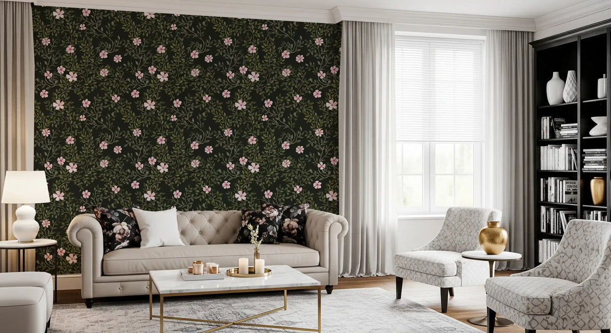 Soft pink floral wallpaper behind a tufted cream sofa with gold accents and a bookshelf GD12467