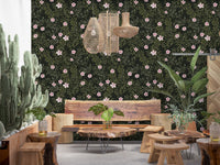 Pink floral vines on charcoal wallpaper in a boho lounge with cactus and live-edge wood bench GD12467