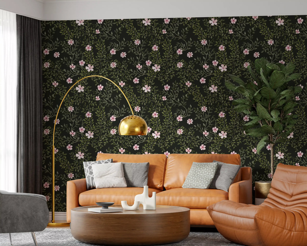 Pink floral vines on charcoal wallpaper behind a tan leather sofa and gold arc floor lamp GD12467