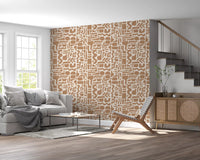 Abstract earth toned shapes wallpaper by a staircase with grey sofa and cane chair GD12478