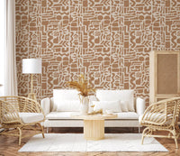 Abstract shapes wallpaper in a boho living room with white sofa and cane chairs GD12478