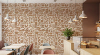 Abstract earth toned shapes wallpaper in a cafe with wood tables and pendant lights GD12478