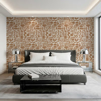 Abstract shapes wallpaper behind a black leather bed with chrome table lamps GD12478