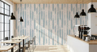 Blue painted stripe wallpaper in a cafe with wood tables and black pendants GD12490