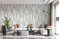 Blue painted stripe wallpaper behind a grey sofa and glass coffee table GD12490