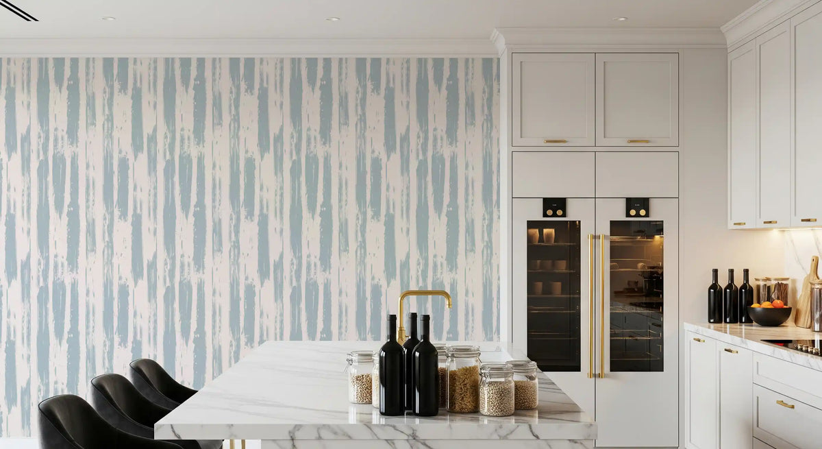 Painted stripe wallpaper in a kitchen with marble island and dark cabinetry GD12490