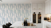Painted stripe wallpaper in a kitchen with marble island and dark cabinetry GD12490