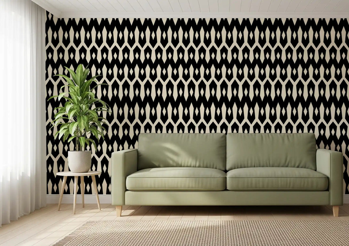 Olive green sofa and potted plant against black and cream diamond wallpaper GD12494
