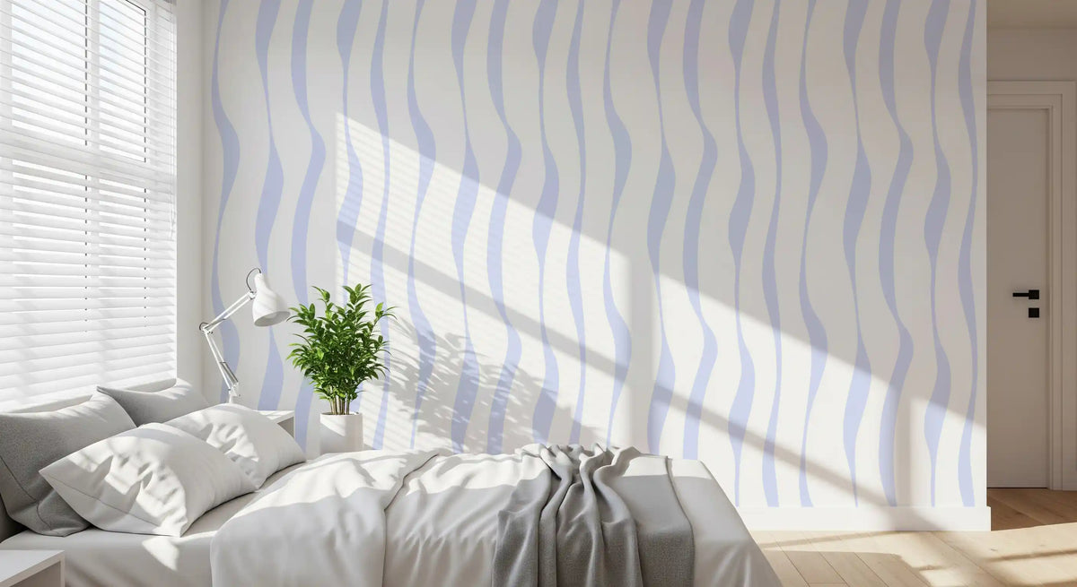 Blue wave wallpaper in a sunlit bedroom with a white bed and floor lamp GD12498