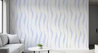 Soft blue wave wallpaper feature wall by a light grey sofa and side table GD12498
