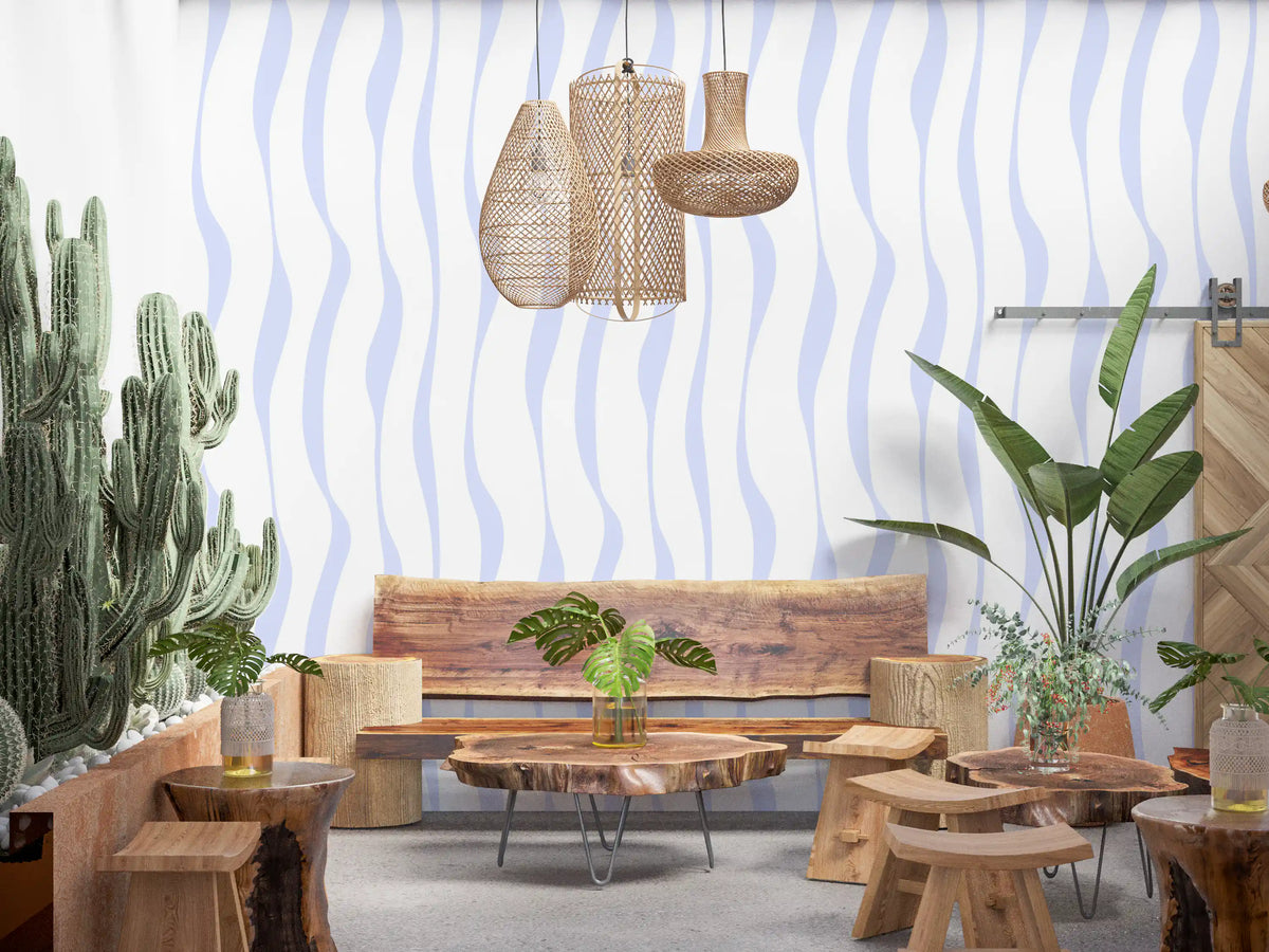 Flowing blue hues wallpaper in a boho lounge with a wood bench and cacti GD12498