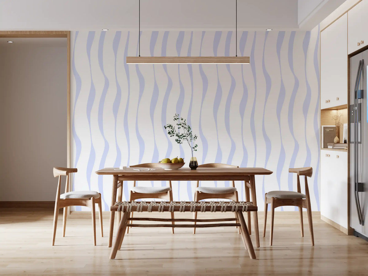 Blue wave wallpaper behind a wood dining table in a bright kitchen diner GD12498