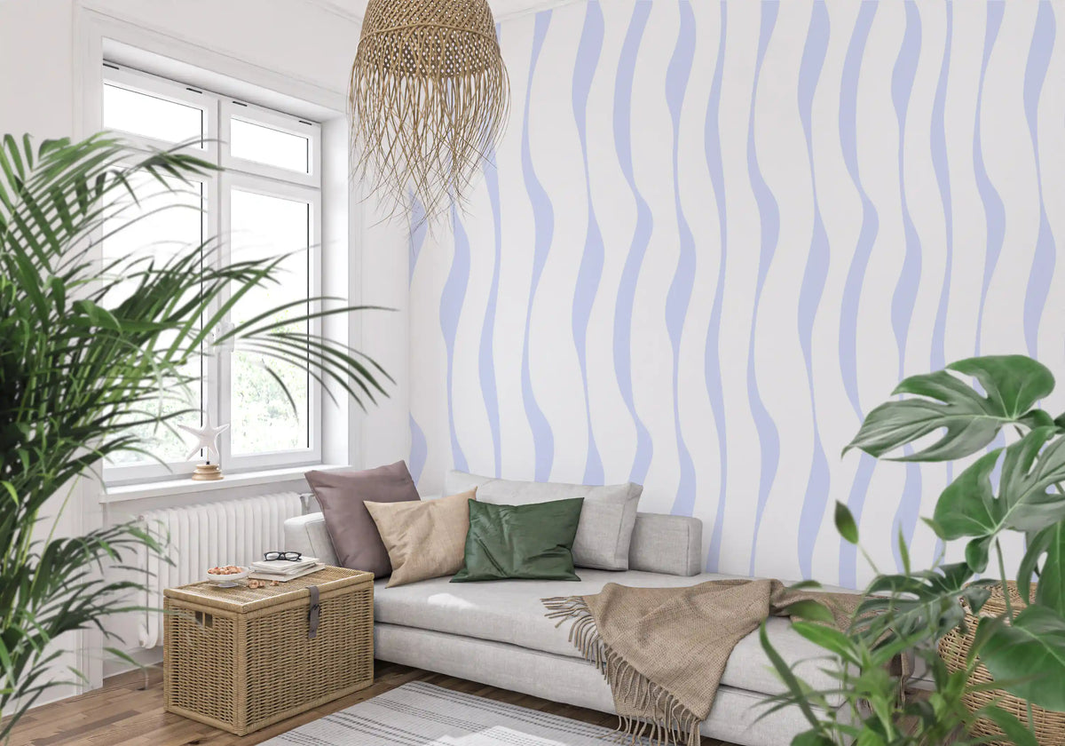 Flowing blue hues wallpaper behind a grey sofa with a monstera plant GD12498