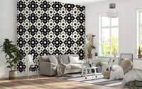 Black and cream geometric wallpaper in a bright living room with a grey sofa GD12503