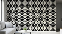 Geometric starburst wallpaper close up behind a white sofa and round side table GD12503