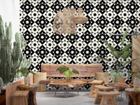 Graphic starburst wallpaper in a boho living room with a cactus and wooden furniture GD12503