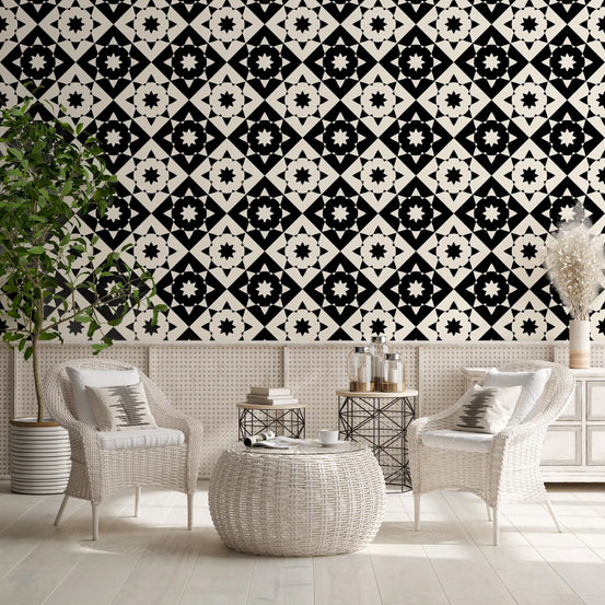 Black and cream geometric starburst wallpaper in a living room with white wicker chairs GD12503
